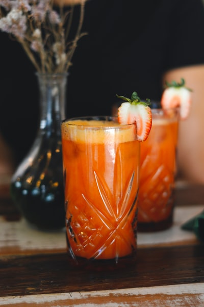 Transparent glass with orange liquid
